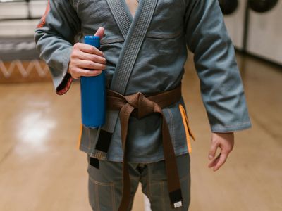Hands holding a water bottle after a successful exercise session.